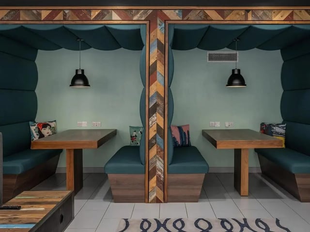 Booths with tables and pendant lights study area at Meadow Court in Edinburgh Student Accommodation