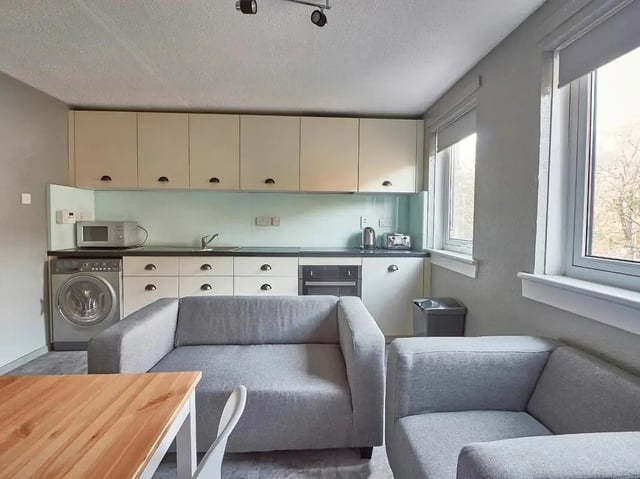 Kitchen with sofas dining table living room at Meadow Court in Edinburgh Student Accommodation