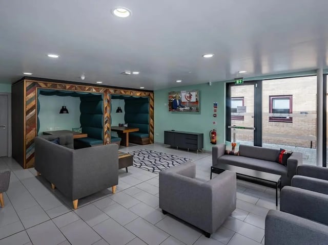 Booth seating sofas TV fire extinguisher communal area at Meadow Court in Edinburgh Student Accommodation