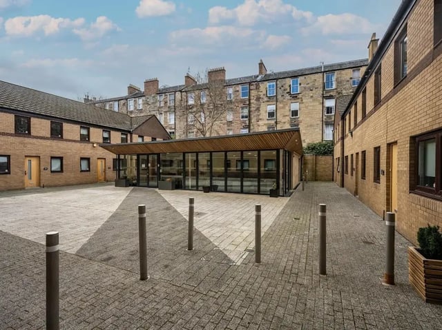 Courtyard with brick buildings and glass entrance exterior at Meadow Court in Edinburgh Student Accommodation