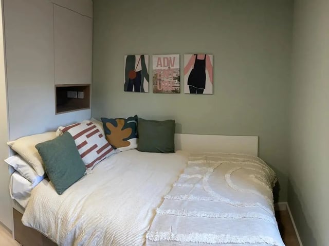 Bed with art and pillows bedroom at Norton's Student Living in Edinburgh Student Accommodation