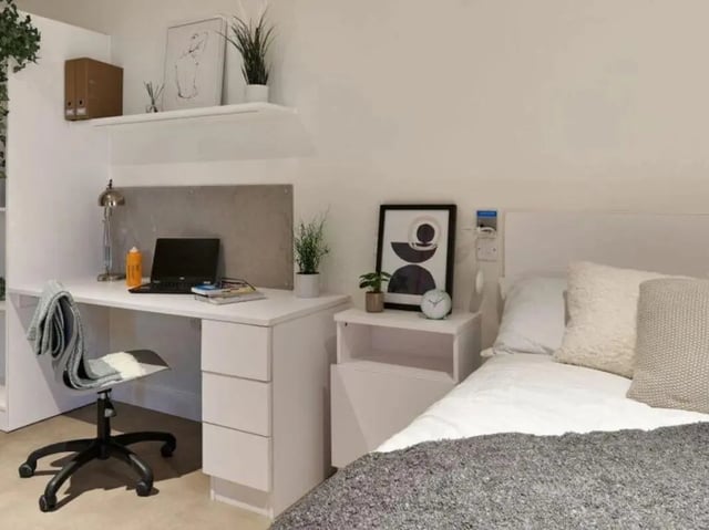 Desk with laptop and bed bedroom at View Studios in London Student Accommodation