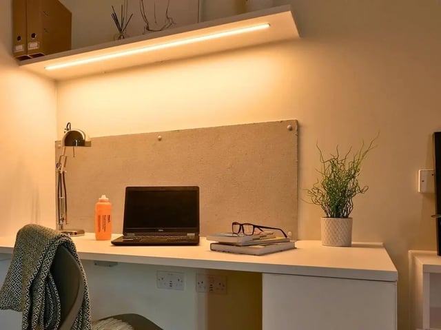 Desk with laptop water bottle plant study area at View Studios in London Student Accommodation