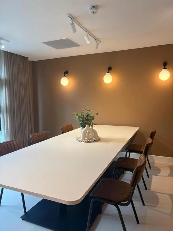 Long white table with chairs meeting room at Valerian in York Student Accommodation