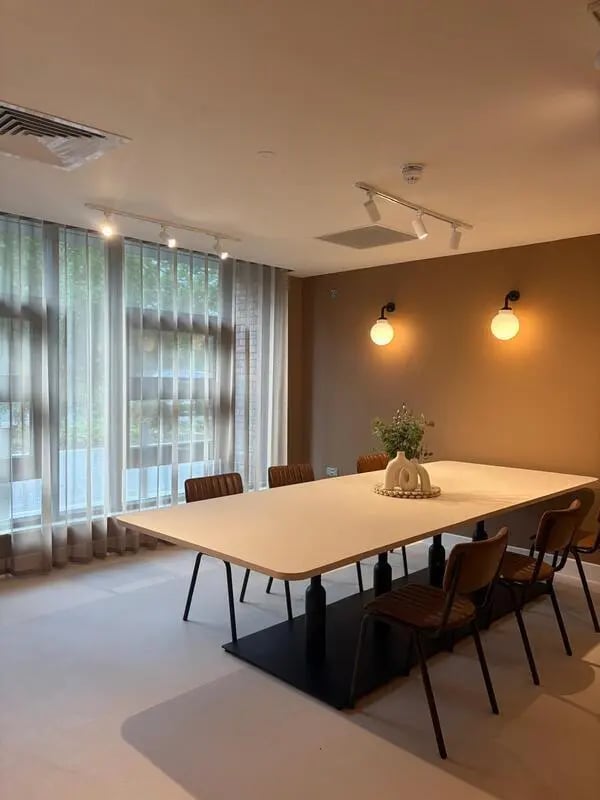 Long table chairs and modern decor communal area at Valerian in York Student Accommodation