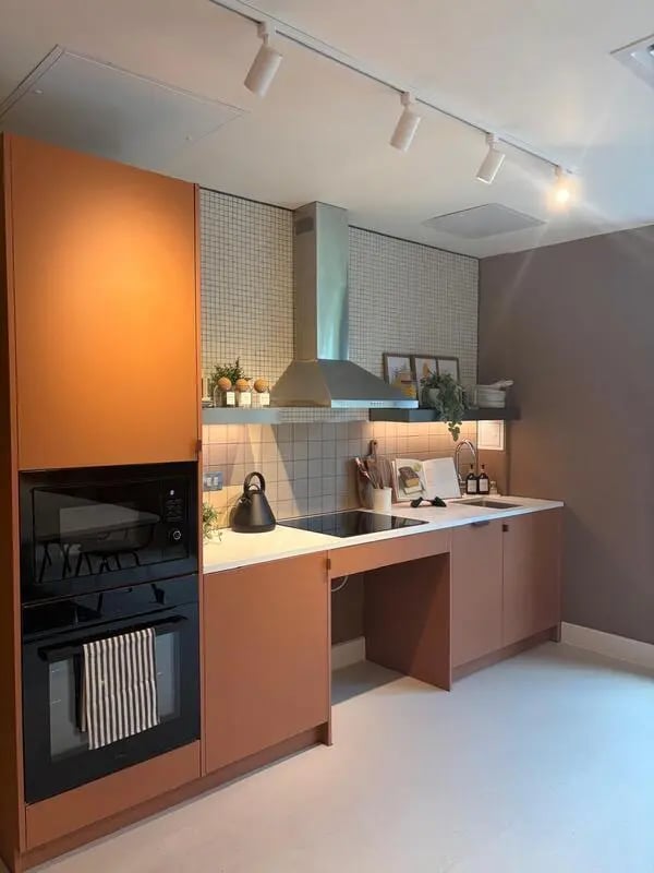 Orange cabinets oven microwave tiled backsplash kitchen at Valerian in York Student Accommodation