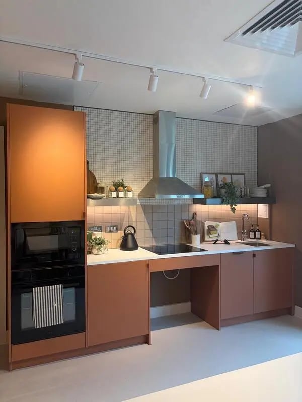 Orange cabinets built-in oven hob sink kitchen at Valerian in York Student Accommodation