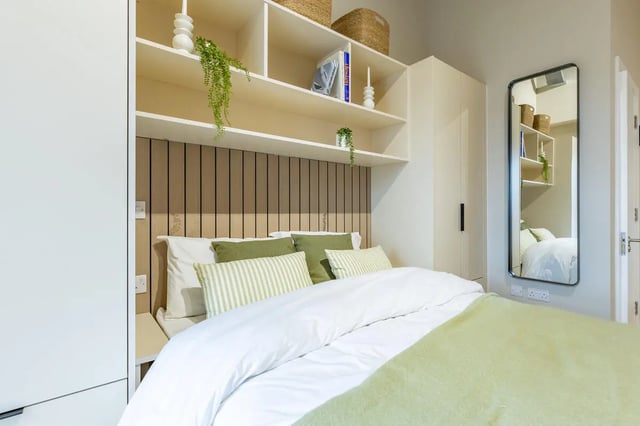 Bed with pillows shelves and mirror bedroom at Fitz and Knox in Cardiff Student Accommodation