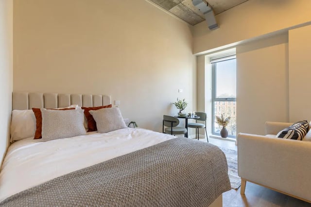 Bed with pillows and a sofa bedroom at Fitz and Knox in Cardiff Student Accommodation