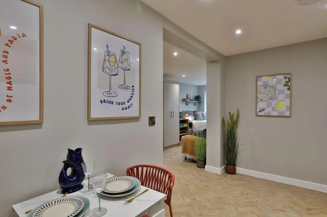Dining table with artwork and bedroom beyond bedroom at London Road Apartments in Southampton Student Accommodation