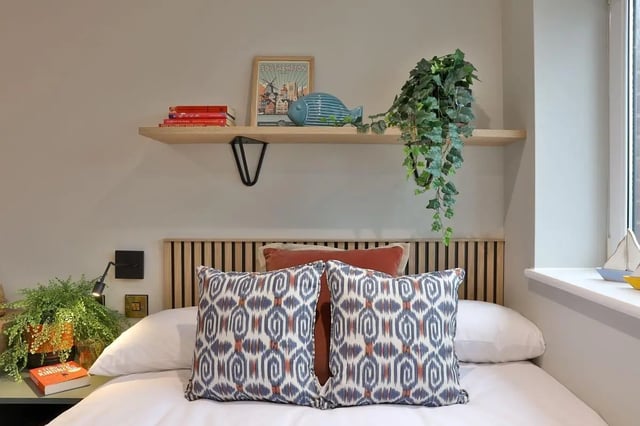 Bed with patterned pillows and shelf bedroom at London Road Apartments in Southampton Student Accommodation