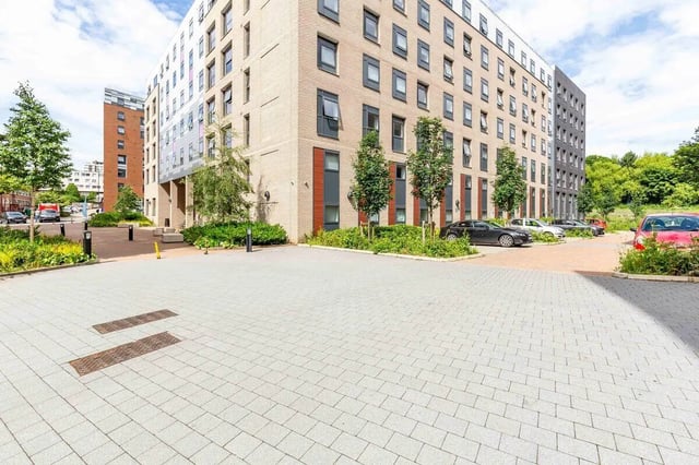 Modern brick building with parked cars and trees exterior at Rosedale Court in Newcastle Upon Tyne Student Accommodation