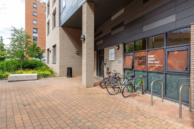 Building entrance with bikes and green plants exterior at Rosedale Court in Newcastle Upon Tyne Student Accommodation