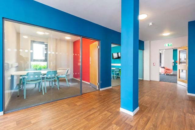 Glass room with table chairs and TV area at Rosedale Court in Newcastle Upon Tyne Student Accommodation