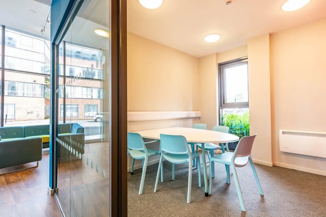 Oval table with light blue chairs communal area living room at Rosedale Court in Newcastle Upon Tyne Student Accommodation
