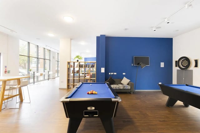 Pool tables couch dartboard and books lounge area at Rosedale Court in Newcastle Upon Tyne Student Accommodation