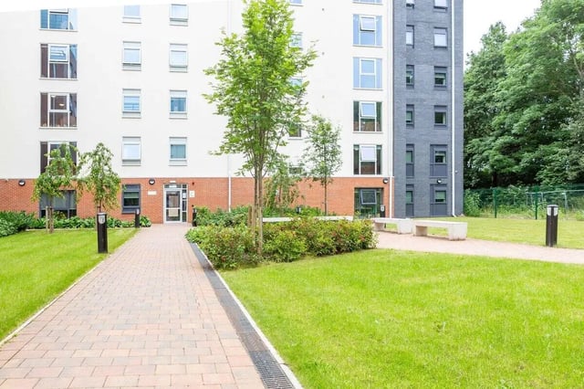 Walkway with benches and green lawn exterior at Newton Court in Newcastle Upon Tyne Student Accommodation