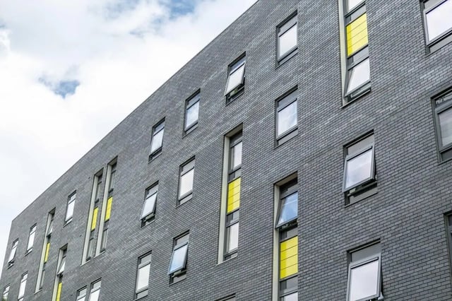 Gray brick building with many windows exterior at Newton Court in Newcastle Upon Tyne Student Accommodation