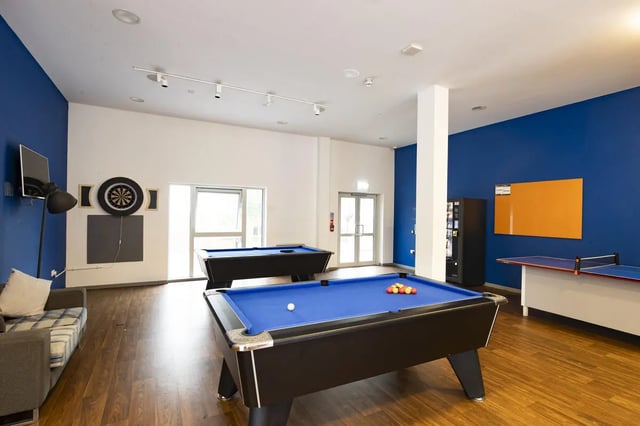 Pool tables dartboard couch ping pong table recreation area at Marshall Court in Newcastle Upon Tyne Student Accommodation