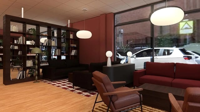 Bookshelves sofas armchairs and tables communal area at St James Glasgow in Glasgow Student Accommodation