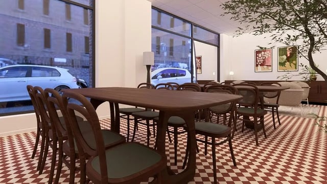 Dining tables and chairs by large window common area. at St James Glasgow in Glasgow Student Accommodation