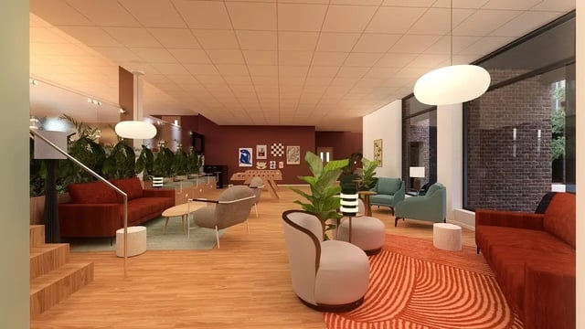 Sofas armchairs plants and foosball table common area at St James Glasgow in Glasgow Student Accommodation