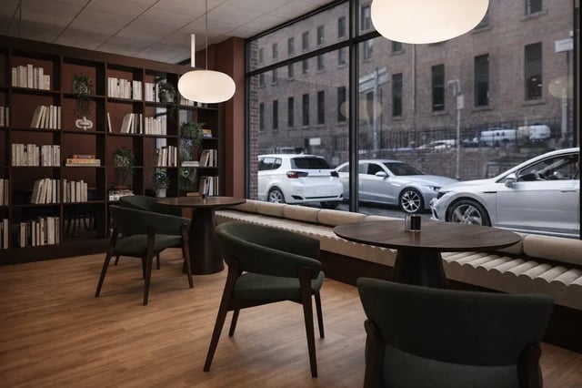 Seating area with bookshelves and large window communal area at St James Glasgow in Glasgow Student Accommodation