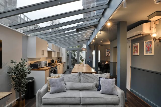 Grey sofa kitchen dining table posters Living room at Francis Gardner in London Student Accommodation