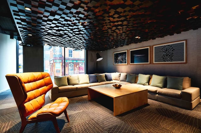 Sofa coffee table chair with art living room at Vita Student Manchester Circle Square in Manchester Student Accommodation