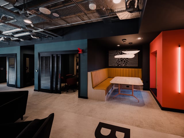 Booth seating with table and abstract art common area at Vita Student Bruce Street in Belfast Student Accommodation