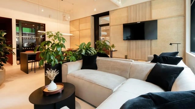 Sofa plants television and table living room at Press House in London Student Accommodation