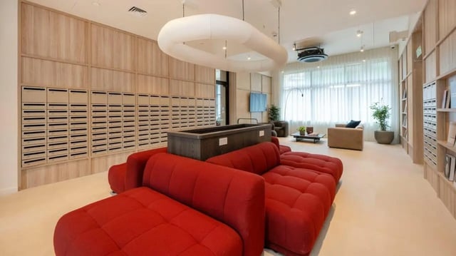 Mailboxes red couches large table living area at Press House in London Student Accommodation