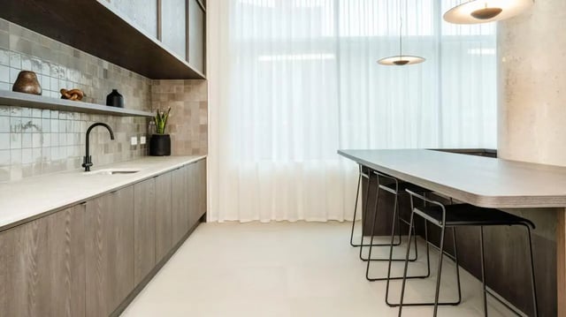Kitchen counter sink and island with stools kitchen at Press House in London Student Accommodation