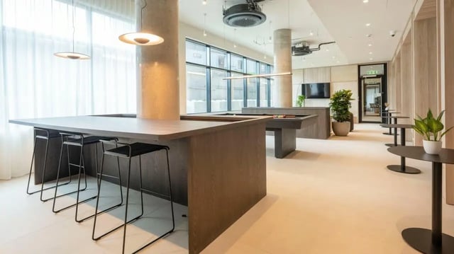 Bar stools billiard tables plants and tables common area at Press House in London Student Accommodation