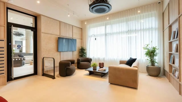 Comfortable seating and bookshelf common area living room at Press House in London Student Accommodation
