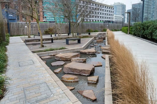 Water feature with stones and benches outdoor area exterior at Press House in London Student Accommodation