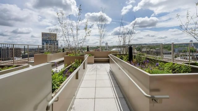 Rooftop garden with benches and city view exterior at Press House in London Student Accommodation