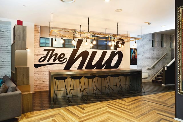 Bar stools and counter area with mural Living room at Vita Student Zed Alley in Bristol Student Accommodation