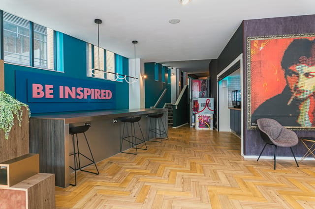 Bar with BE INSPIRED sign and stools common area at Vita Student Zed Alley in Bristol Student Accommodation