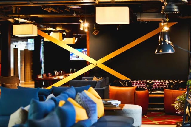 Sofas tables lamps and yellow beams lounge area at Vita Student Fountainbridge - Edinburgh in Edinburgh Student Accommodation