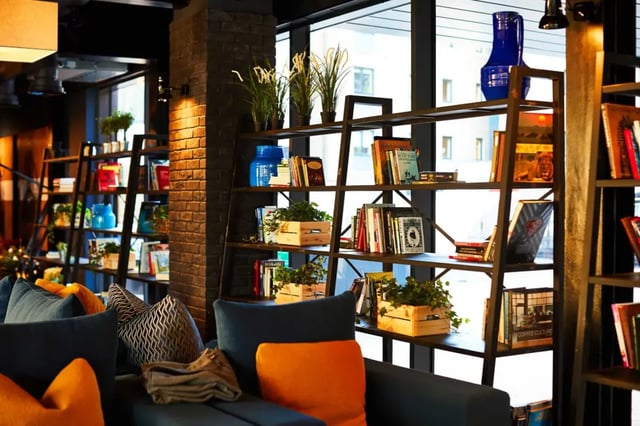 Books and plants on shelves next to seating Living room at Vita Student Fountainbridge - Edinburgh in Edinburgh Student Accommodation