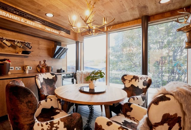 Round dining table cow print chairs kitchen living area at Vita Student Lewisham Exchange in London Student Accommodation
