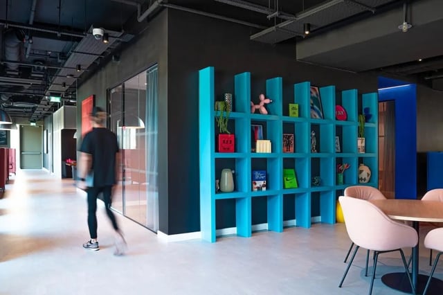 Turquoise shelves with decor pink chairs communal area at Vita Student Copper Towers in Coventry Student Accommodation