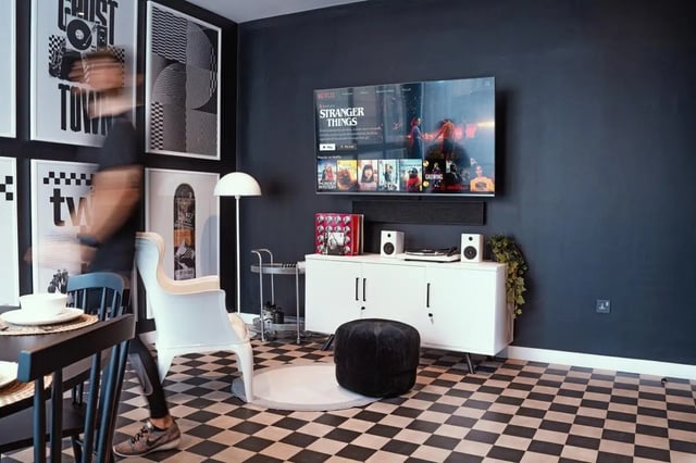 Modern living room with checkerboard floor and TV living room at Vita Student Copper Towers in Coventry Student Accommodation