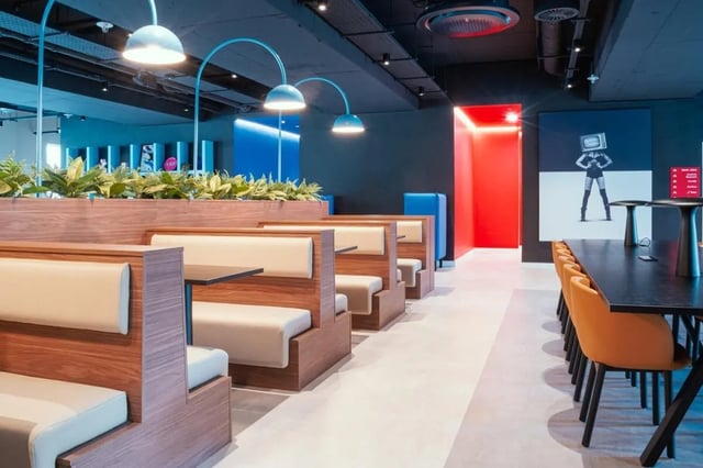 Booth seating and long dining table common area at Vita Student Copper Towers in Coventry Student Accommodation