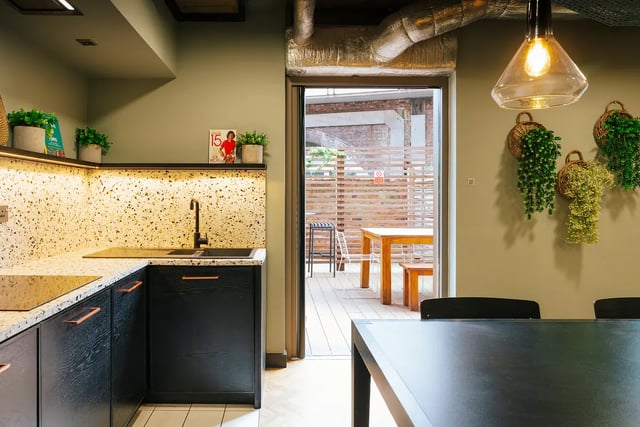 Black cabinets sink plants view of patio kitchen at Vita Student Station Street in Nottingham Student Accommodation