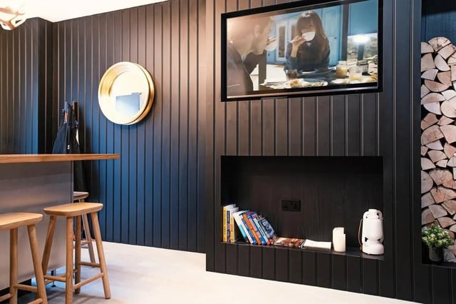 Stools bar mirror television fireplace living room at Vita Student Iona Street in Edinburgh Student Accommodation