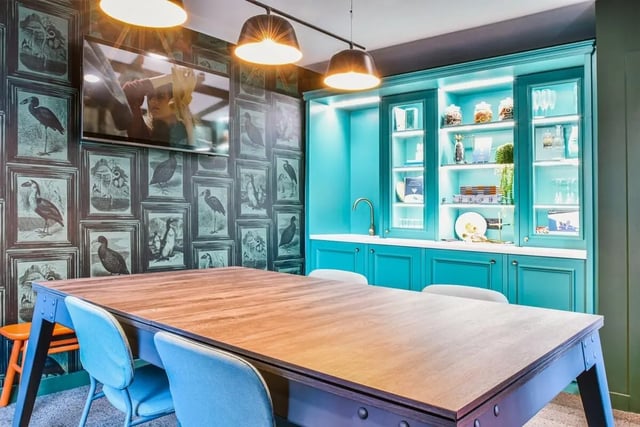 Table chairs television cabinets and sink communal area at Vita Student Iona Street in Edinburgh Student Accommodation