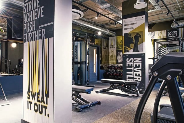 Gym with benches dumbbells and workout machines gym at Vita Student Iona Street in Edinburgh Student Accommodation