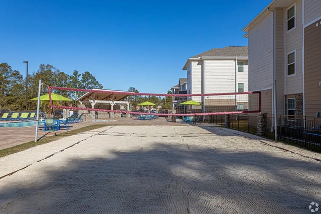 Sand volleyball court near pool and buildings Outdoor Area at Waypoint at Hammond in Hammond Student Accommodation